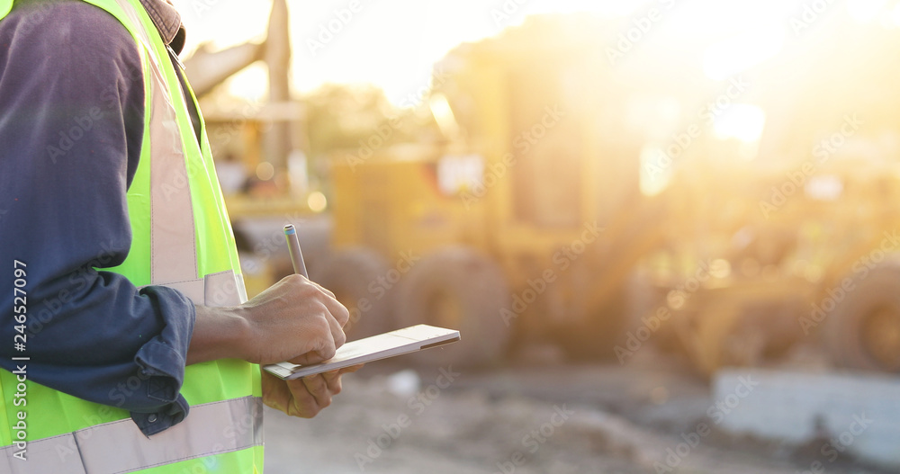 Aufkleber asian engineer with hardhat using tablet pc computer inspecting and working at construction site
