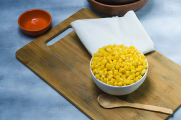 corn in a ceramic vessel and clay in the bottom of kitchen