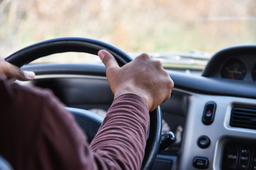 Man driving car / Driver hands on steering wheel driving my car on the road