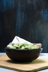 raw and fresh green beans in a ceramic and clay pot