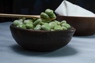 raw and fresh green beans in a ceramic and clay pot