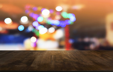 Empty dark wooden table in front of abstract blurred bokeh background of restaurant . can be used for display or montage your products.Mock up for space.