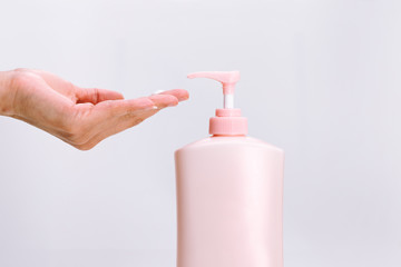 Body Lotion Skin Care Apply. women hands holding body cream pump bottle. Beauty And Body Care Concept