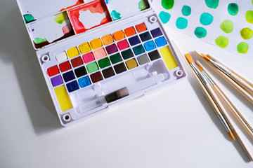 Watercolor paints and brushes workplace artist with artistic tools for mock up.