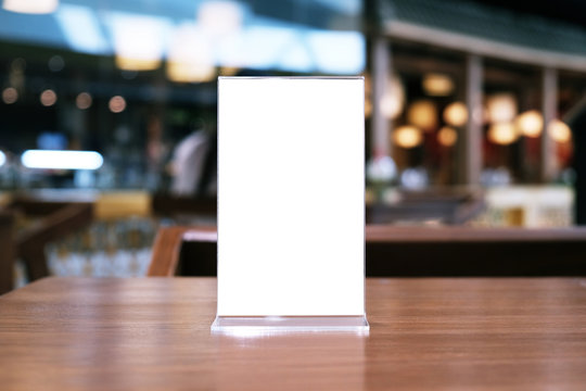 Menu frame standing on wood table in Bar restaurant cafe. space for text marketing promotion.