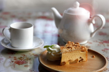 A cup of tea with homemade apple tart for afternoon snack with cozy style living in English cottage house