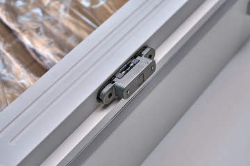 White cabinet with hidden hinges and shelf holders. Wooden furniture manufacturing process