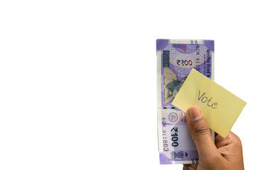 Hand holding money and vote a concept of political corruption the purchase of votes in elections on isolated background.