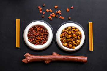 Pet care. Pet food, toys and accessories on black backgorund top view pattern