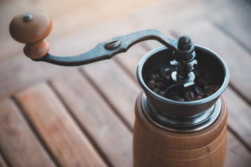 Closeup image of a vintage wooden coffee grinder
