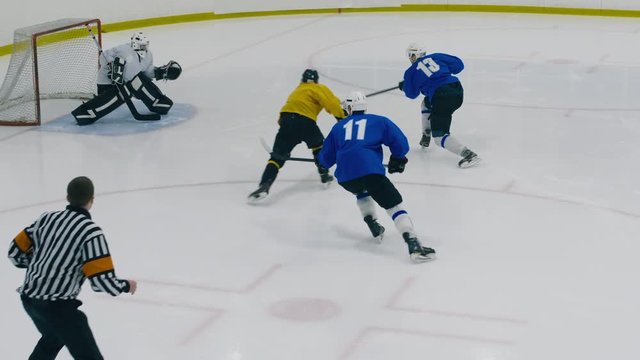 High angle shot of two hockey players starting game on ice arena with face-off and fighting for the puck