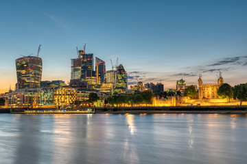 The skyscrapers of the City and the Tower of London after sunset