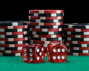 two red dice on the background of the poker game
