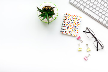 Office workplace, work desk in office. Computer keyboard, glasses, stationery, plant on white background top view space for text