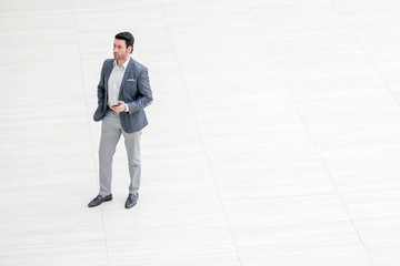 view from afar.businessman looks at the screen of the smartphone