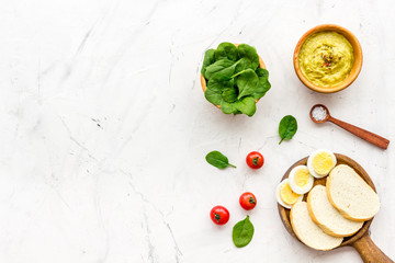 Healthy breakfast. Toasts with vegetables and guacamole on white background top view copy space