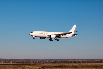 Fototapeta na wymiar Landing white wide-body passenger aircraft