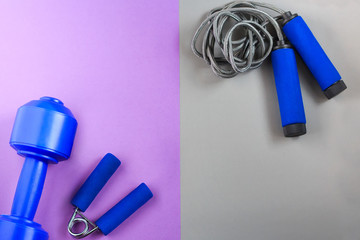 Sports equipment blue color on a gray and violet background. Flat lay composition  with copy space.