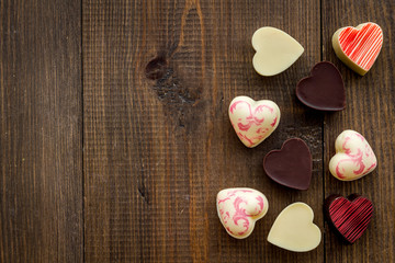 Heart-shaped confection for Valentine's day on dark wooden background top view copy space