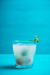 Old fahioned lychee cocktail on the rustic background. Selective focus. Shallow depth of field. 