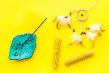 Meditation and eastern spiritual practices concept yellow background top view