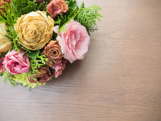 Bouquet of mixed flowers on wood background, Roses, Carnation, Eustoma, dry flowers.