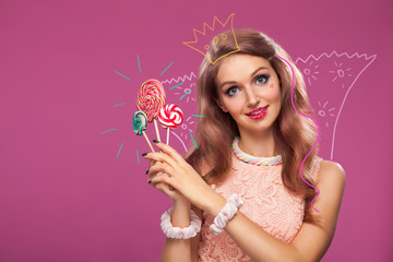 Beautiful pink lips with a sweet candy lollypop. Close up portret of young woman with candy in mouth.