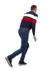 Fototapeta premium Back view of a running man in sweater.