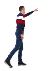 Side view of a man walking with a pointing hand.
