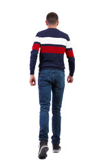 Naklejka premium Back view of going handsome man in sweater.