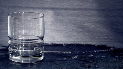 Glass stan on a dark background.