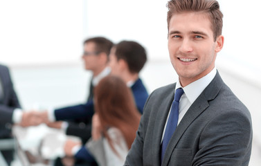 young businessman on blurred office background