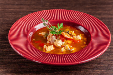 French cuisine concept. Classic French fish soup of seafood, shrimps, mussels, squid, potatoes, tomatoes. Beautiful serving dishes in the restaurant. copy space