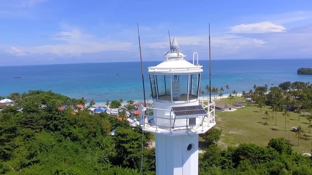 Aerial flying over lighthouse on tropical island in the Philippines