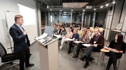 project Manager conducts a meeting of senior staff.