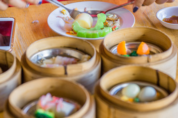 Obraz na płótnie Canvas The background of food that is put in a wooden container (dim sum) containing vegetables, pork, flour Used to make, a menu that requires steaming stoves for good taste, delicious to eat 