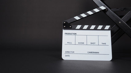 Fototapeta na wymiar Clapperboard or clap board or movie slate with black director chair use in video production ,film, cinema industry on black background.
