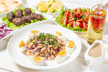 Oriental piyaz bean salad with meatballs. 