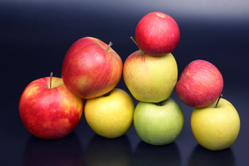 Wall of fresh different apples on dark background