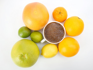 Fototapeta na wymiar Black coffee in a white Cup surrounded by citrus fruits