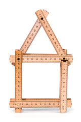 Wooden folding meter ruler in the shape of two house. Isolated on white background. Clipping path included.