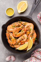 Fried shrimps in shell with parsley, coriander, garlic and oil in pan. Delicious Mediterranean cuisine, vegetarian food, healthy protein