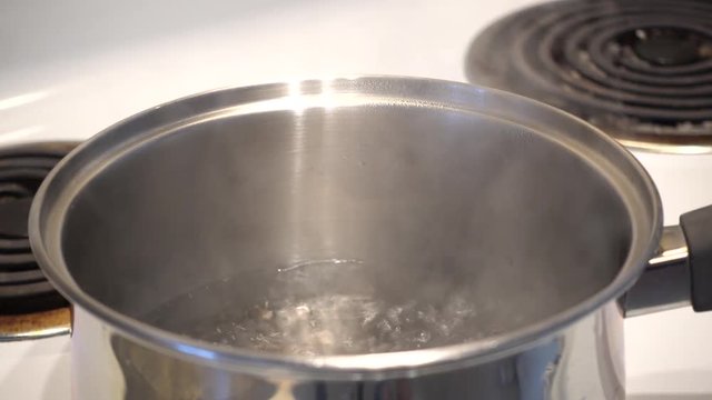 Pot of Boiling Water Boiling And Steam Coming Out Of Pot 4K