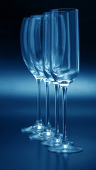 Four wine glasses on a dark background close-up