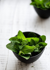 Fresh green mint on the white old wooden table. Soft selective focus