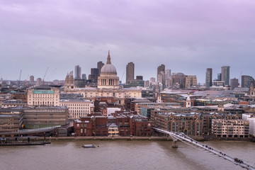 Naklejka premium Panoramic view of Saint Paul Cathedral in London and the bridge over the river Thames. View from Tate Modern museum.