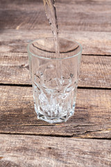 Glasses of water on a wooden table.