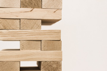 Board game jenga. Wooden blocks. A logic game for two and a company. Entertainment for adults and children. Useful leisure. Educational toys. Wooden bricks. Tower of cubes.