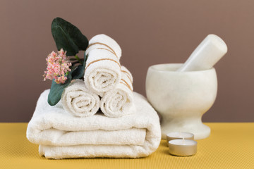 Fototapeta na wymiar Spa still life with aromatic candles, flower and towel. - Image.