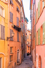 Fototapeta na wymiar Nice, narrow street in the Vieux Nice, ancient buildings, typical facades in the old town, French Riviera